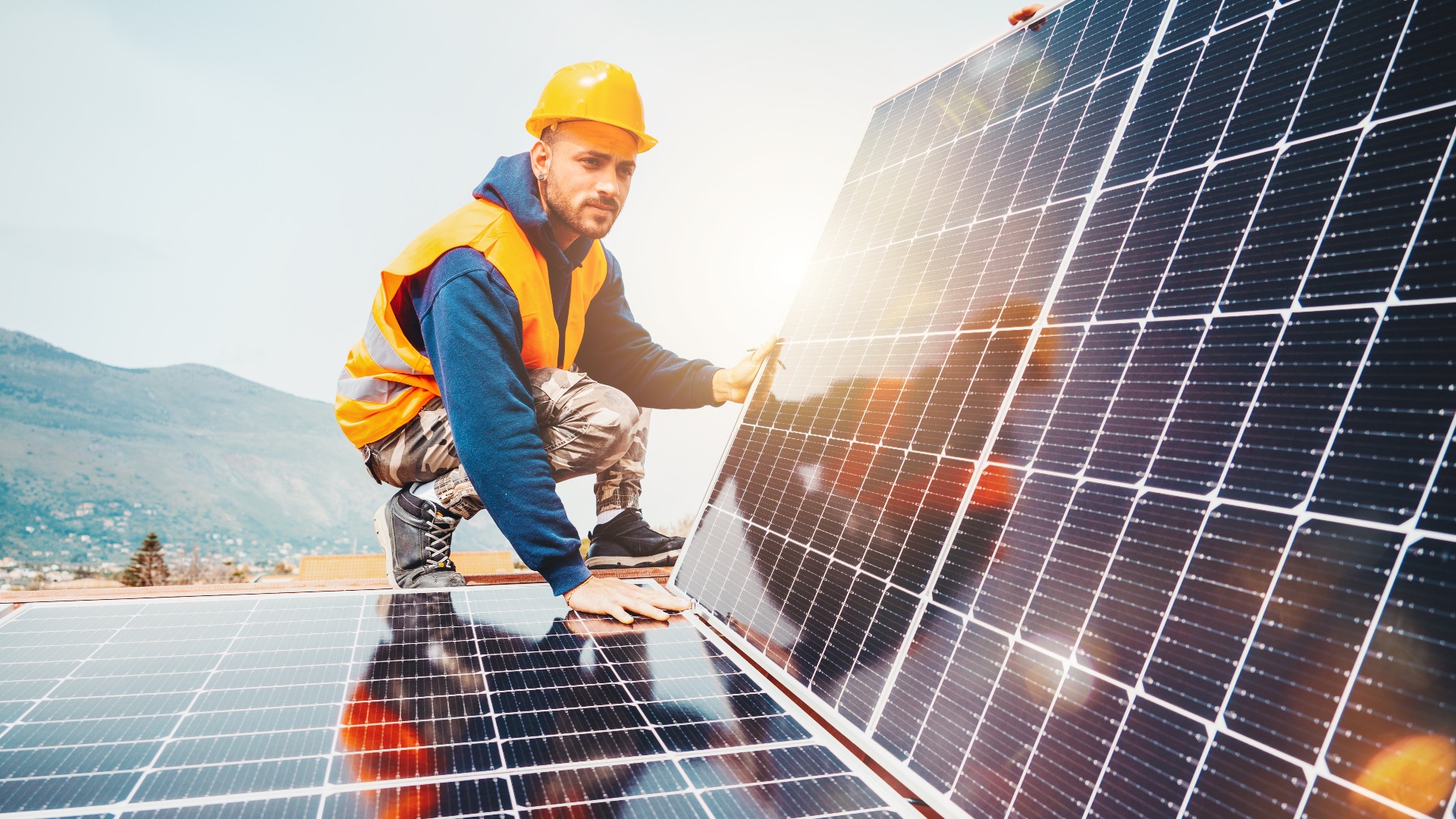 Workers assemble energy system with solar panel for electricity